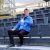 Volker Gawron sitzt auf den den ersten montierten Stühlen auf der Tribüne der Eutiner Festspiele.
