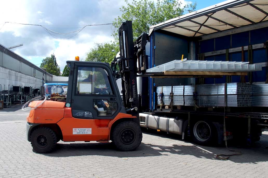 Ein Gabelstapler lädt einen Stapel verzinkte Doppelstabmatten auf einen LKW auf dem Hof des Metallbauunternehmens Gawron in rellingen.